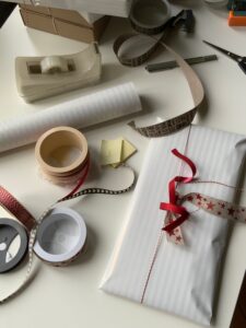 Gift wrapping supplies spread on a table