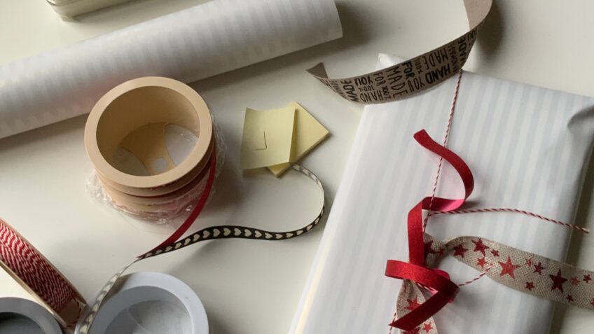 Gift wrapping supplies spread on a table