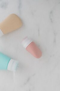 Flat lay of skincare bottles on a smooth marble surface