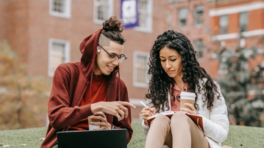 Students studying together on a laptop, representing student discount shopping